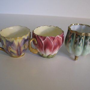 Trio of painted china demitasse cups